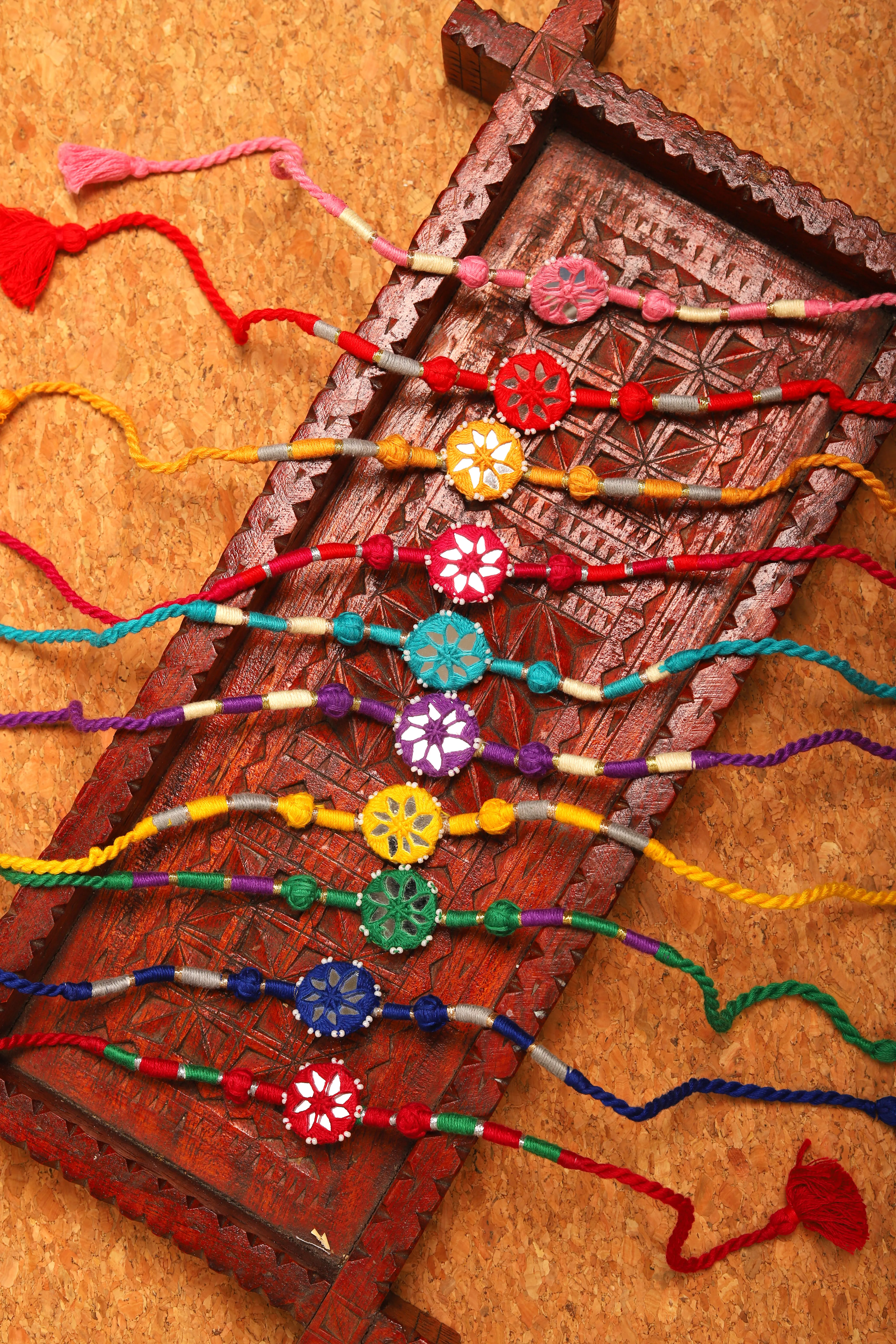 Indian rural artisan women's hands tying colorful threads